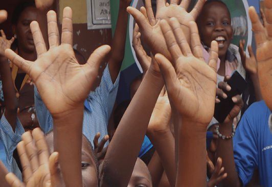 Children raising their hands in a classroom